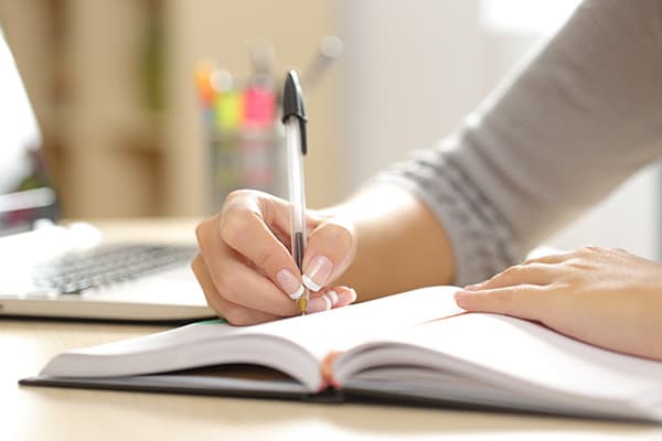 Woman writing in a journal