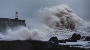 Wave crashing near light tower